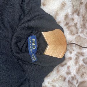 Black turtleneck sweater. It’s says extra large but fits more like a medium.